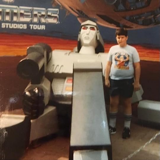 Child posing with Megatron figure at Transformers attraction Universal Studios Hollywood 1985