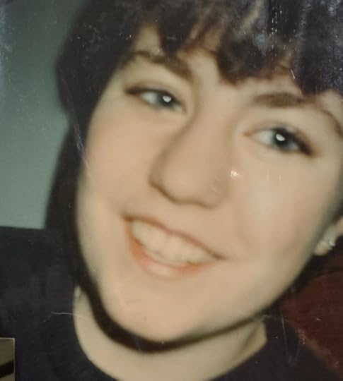 A young white woman with short brown hair, smiling.
