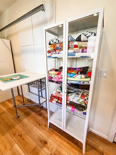 Glass door cabinets with fabrics and quilts