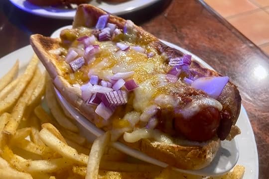 Chili cheese dog with onions on toasted bun at Bryson’s Irish Pub