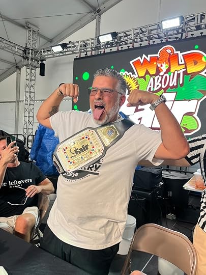 Spicy Tendies Smackdown 2026 winner Gus Cutie holding championship belt at Miami-Dade Youth Fair