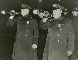 Two policemen blowing trumpets to herald Mayor LaGuardia's ban of sales of small artichokes, December 21, 1935. Associated Press Photo, Mayor LaGuardia Papers, NYC Municipal Archives.