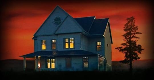 A two-story white house stands alone at dusk under a vivid red-orange sky. Warm yellow light glows from several windows, suggesting someone inside. The house has a covered front porch and a circular window near the roof peak. A single tall tree stands nearby, and the surrounding landscape fades into shadow, creating an eerie, suspenseful atmosphere.