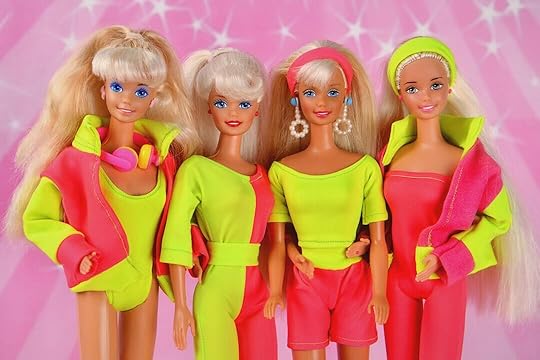 Four 80s barbie dolls posing together.