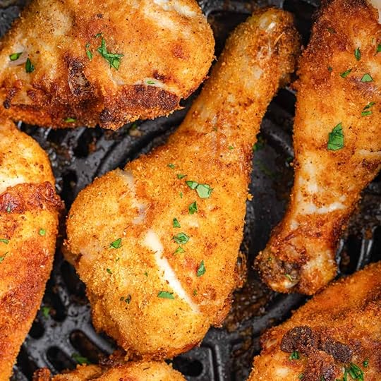Close-up of crispy shake and bake air fryer chicken drumsticks on an air fryer grate.