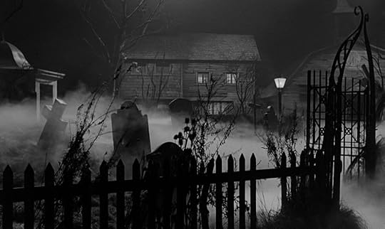 A black and white image of a spooky graveyard at night, featuring tilted tombstones, a wooden fence, and a foggy atmosphere. A dimly lit house can be seen in the background, adding to the eerie setting.