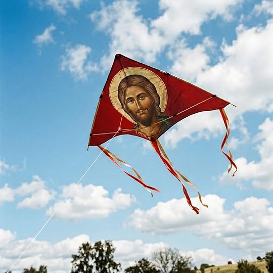 Red kite with Jesus Christ image flying in blue sky with clouds