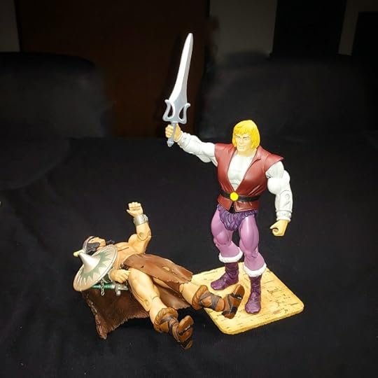 Vikor lies on the floor, while Adam holds the sword aloft