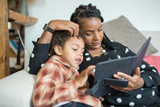 Mother and son watching something on a tablet together