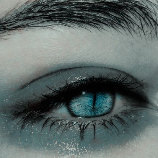 This may contain: an eye with blue eyeshade and long eyelashes