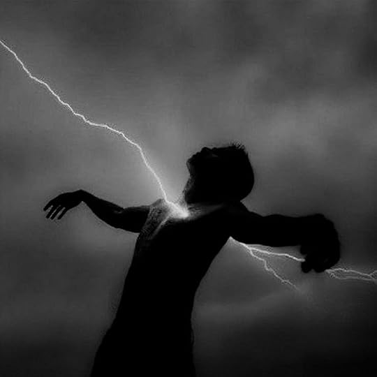 This may contain: a man is standing in the dark with his arms out as lightning strikes behind him