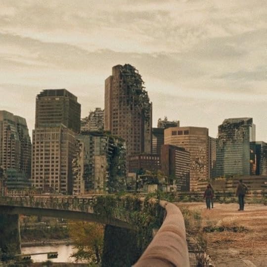 This may contain: a person taking a photo with their cell phone in front of a cityscape