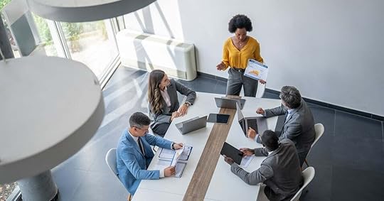 A manager prepares to lead a sales meeting with her team.