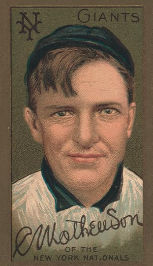 An early 20th century baseball card, with a color sketch portrait of Christy Matthewson. He has bangs, a slight smile and is wearing a baseball uniform, buttoned to the collar.