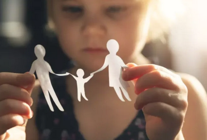 child looking at a paper family