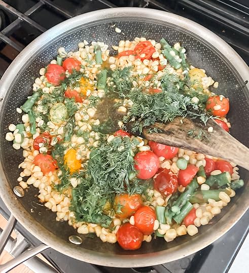 All of the succotash vegetables being cooked together in a pan
