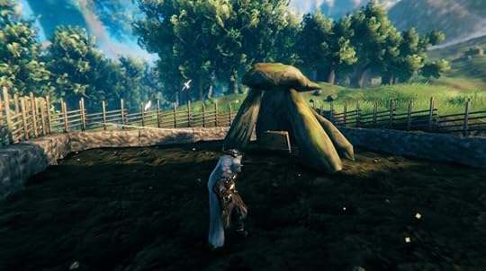 Screenshot from the game Valheim. It shows my character standing in front of a dolmen with a few rather tilted standing stones and one top stone balanced precariously on top.In the hollow underneath the top stone sits a large chest. A walled garden surrounds the dolmen, with the dirt looking dark and fertile.