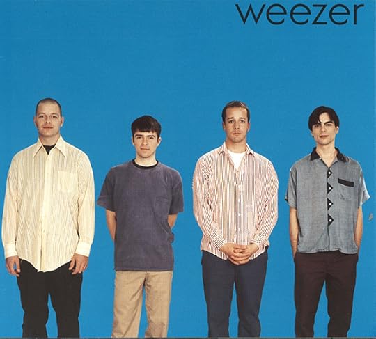 Album cover photo of four young men, dressed in nodescript jeans and shirts, standing in a row and looking at the camera with bland expressions. The entire background is blue, with the name 