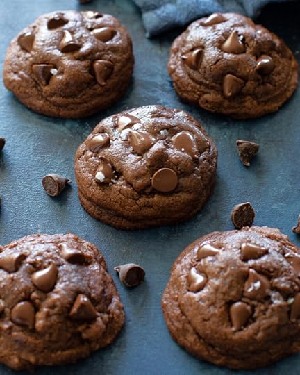 brownie batter cookies with chocolate chips on a blue surface