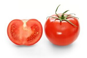Whole red tomato with cross-section of another tomato