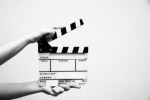 Two hands holding a clapboard