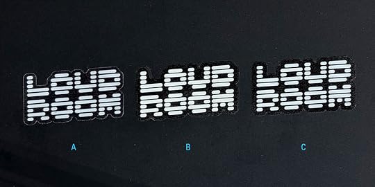 Three white die-cut Loud Room logo stickers on a black background arranged horizontally. The letters A, B, C appear under each respectively from left to right.