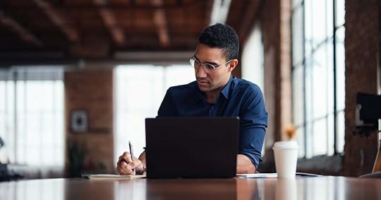 After a call, a seller sits in front of a laptop to write a sales proposal.