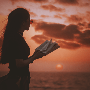 Woman with book against a darkening sky