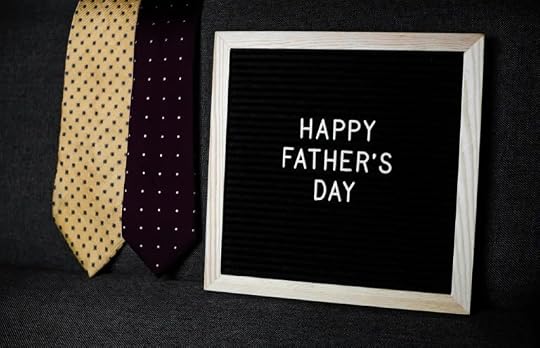 A black sign reading Happy Father's Day with ties beside it.