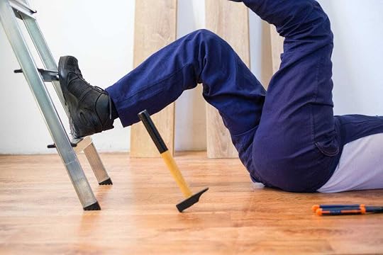 Person on ground after falling off ladder with hammer.