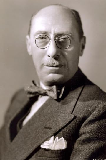 A historical portrait of Ettore Panizza wearing a suit, bow tie and glasses.