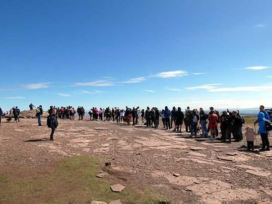 A line of 70 clinically insane people queuing for a summit photo on top of Pen y Fan