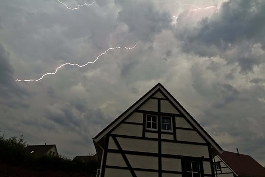 lightening flashes over a half-timbered house