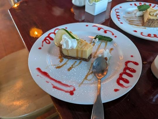 A partially eaten slice of key lime pie