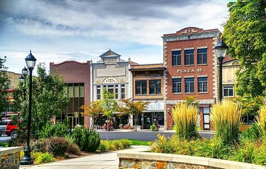 Store fronts on a street in USA. This graphic is for 7 small-town romance books that feel like home
