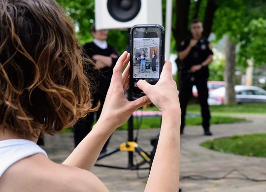 A woman with russett hair holding a cell phone