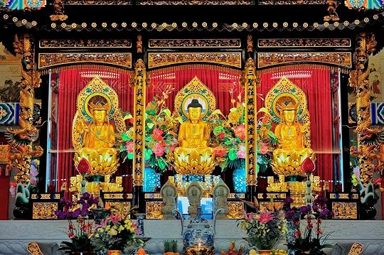 Illustration of 3 golden statues on an altar with a red background