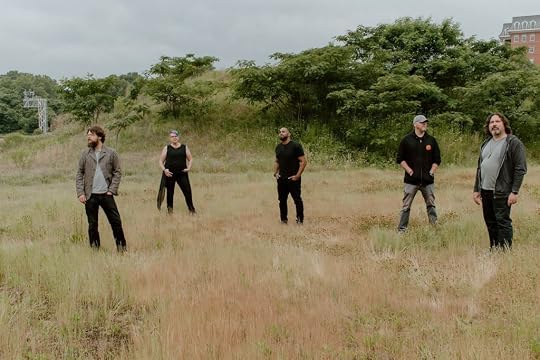 The members of Darkly Lem stand in a field. Left to right: Ben Murphy, Darusha Wehm, Cadwell Turnbull, Josh Eure, Craig Lincoln.