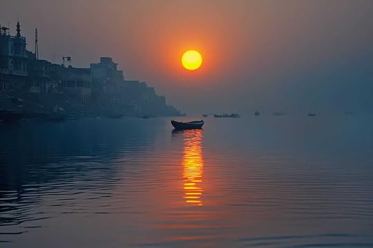 River with rising sun illuminating an empty anchored boat