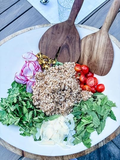 Charlie Bird Salad with farro, shaved parmesan, pistachios, cherry tomatoes, and thinly sliced radishes over arugula and herbs
