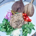 Charlie Bird Salad with farro, shaved parmesan, pistachios, cherry tomatoes, and thinly sliced radishes over arugula and herbs