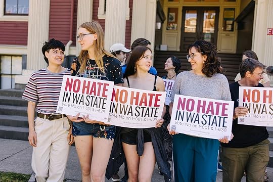 Photograph of people protesting a new Washington ballot proposal seeking to block trans girls from participating in girls' sports by requiring sex verification.