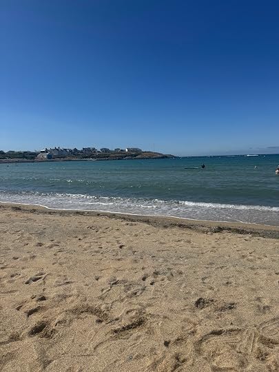 An empty sandy beach and a blue sky.