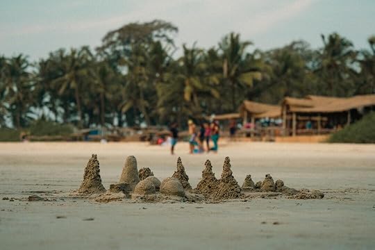 A group of sandcastles sitting on top of a sandy beach