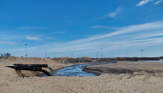 A confusing sight - an open pipe gurgling black liquid into the beach.