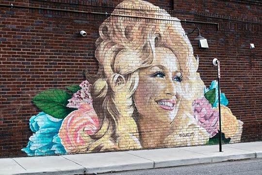 woman and girl painting on wall