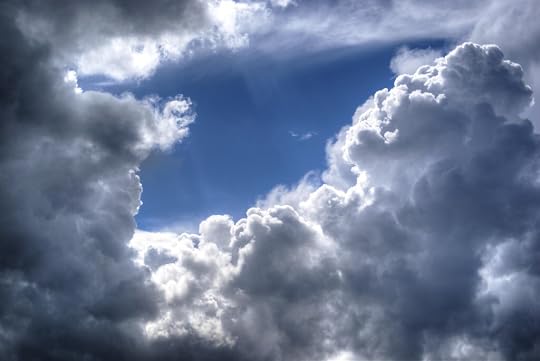Dramatic clouds with a blue sky peeking through the gaps.