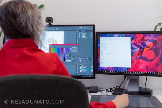 Over the shoulder view of logo and brand identity designer Nela Dunato working in her office, 2 screens showing design software and notes
