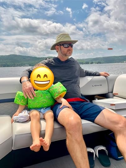 man wearing goruck sun hoodie on boat