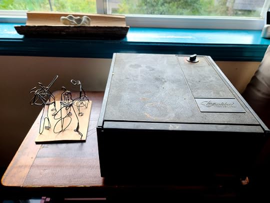 Dehydrator drying basil leaves, small jazz band sculpture from the 1960s to its left.